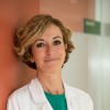 Woman Doctor smiling wearing a white coat