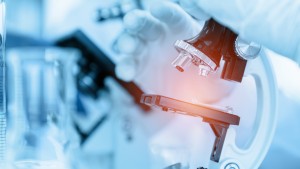 close-up-scientist-using-microscope-laboratory-room-while-making-medical-testing-research.jpg